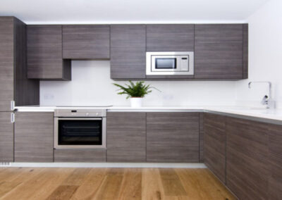 a kitchen with grey slab cabinets