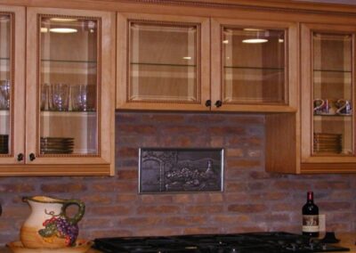 a kitchen with glass cabinets